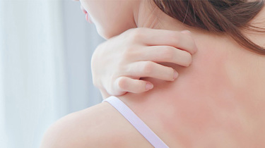 Person klør seg på skuldrene