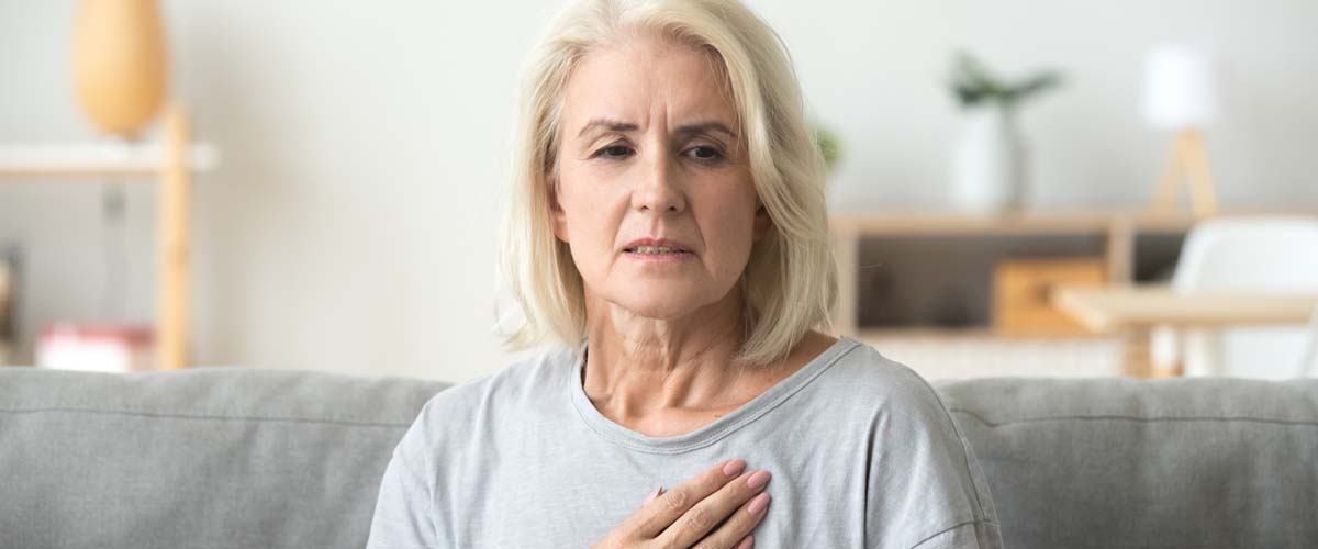 Dame som bekymret holder på hjertet